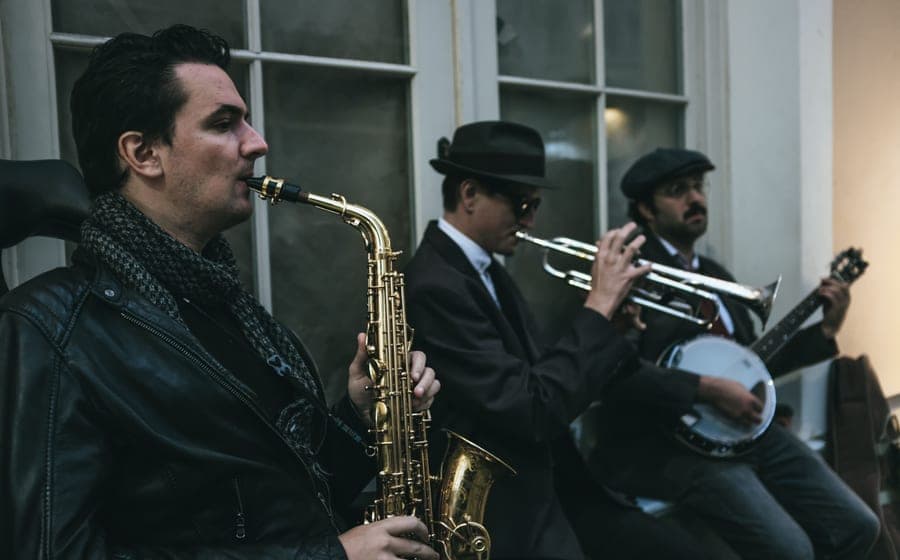 A saxophone and a trumpet laid out together on a table